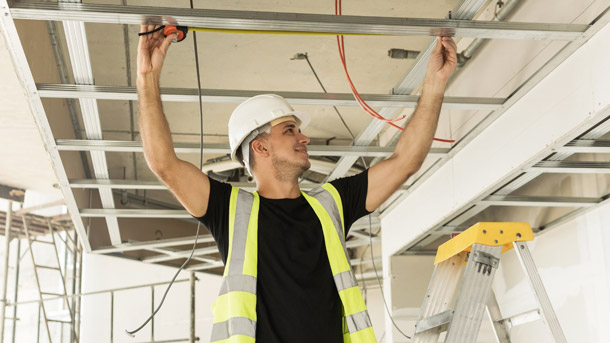 Male employee smiles because Trustmark's accident insurance offered by his employer has him covered if he is injured